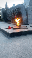 Memorial flame burns with flowers placed at Kazan monument