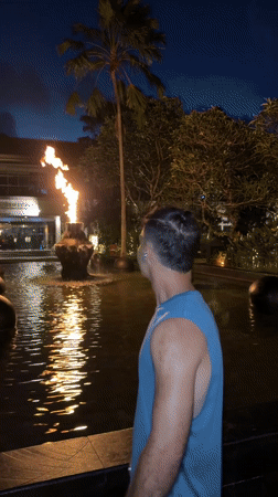 Man photographed by water feature in Indonesian city