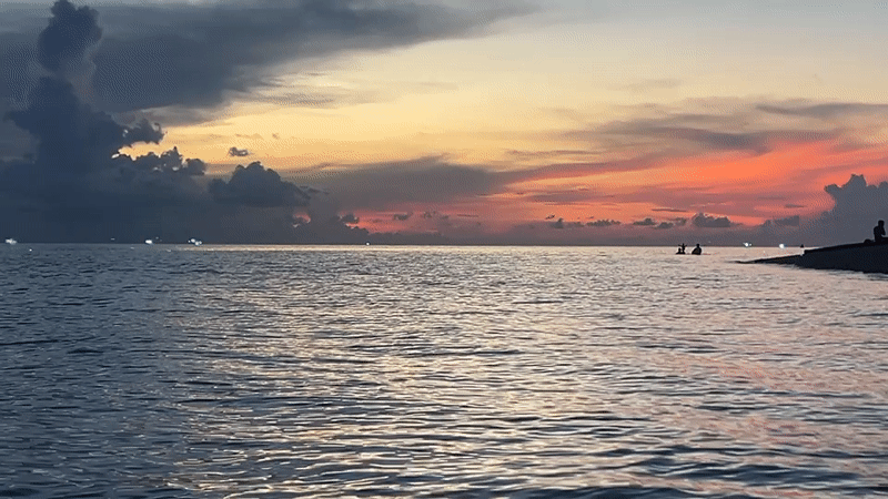 Evening coastal life documented in Thai beach community