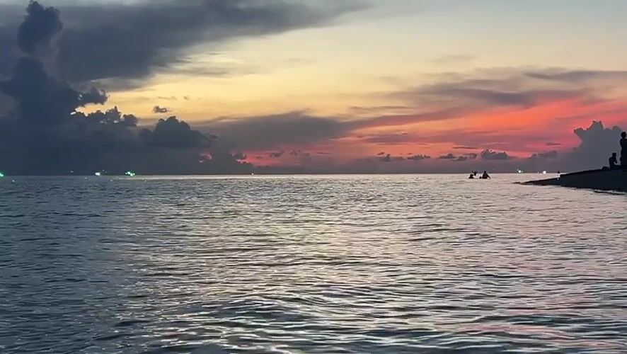 Evening coastal life documented in Thai beach community