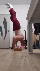 Person does headphone handstand on block in Burgas