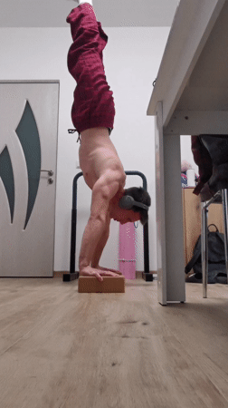 Person does headphone handstand on block in Burgas