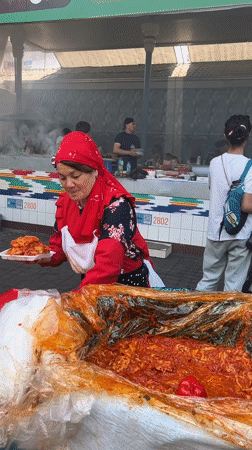 Tashkent market bustles with vendors and diners on sunny morning