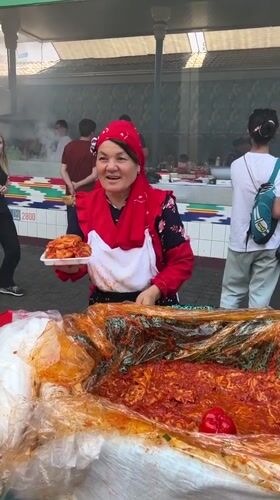 Tashkent market bustles with vendors and diners on sunny morning
