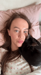 Woman and black cat share quiet morning moments in Chaikovsky