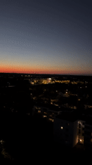 Munich skyline at dusk, stadium lights and sunset glow