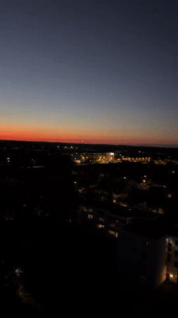 Munich skyline at dusk, stadium lights and sunset glow