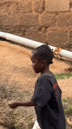 Everyday scenes from a Jos neighborhood — kids, a duck, a garden