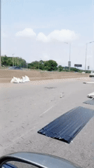 Metal sheets scattered across Abuja highway create traffic hazard