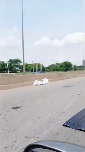 Metal sheets scattered across Abuja highway create traffic hazard