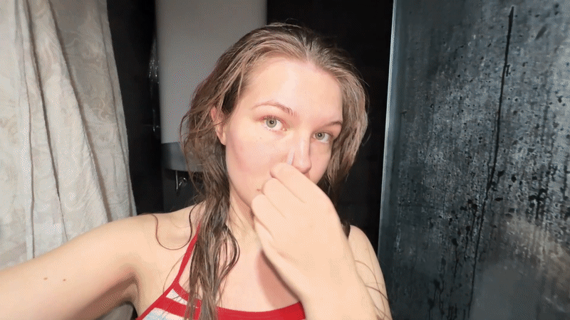 Woman performs morning gua sha facial routine in Belgrade bathroom