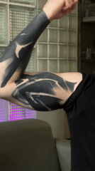 Person shows off blackwork tattoos in Moscow