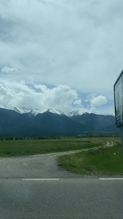 Driver captures snow-capped mountain views near Razlog, Bulgaria