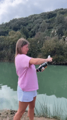 Young women celebrate Sunday with riverside picnic and champagne