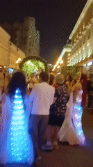 Moscow street scenes feature festive lights, horseback rider, portrait display