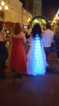 Moscow street scenes feature festive lights, horseback rider, portrait display