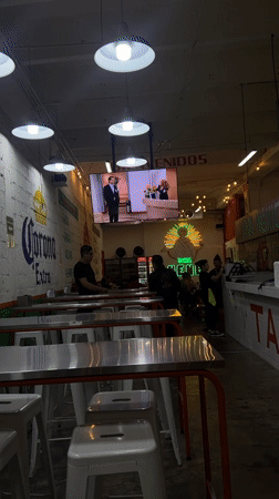 Late-night diners gather at Mexico City taqueria watching telenovelas