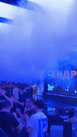 Female performers dance at Sofia nightclub amid blue lighting