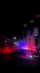 Moscow public square lit up at night with fountains and carousel