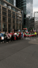 Political demonstration marches through downtown Frankfurt streets
