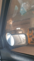 Woman filmed from dashboard camera in moving car, Nigeria