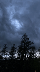 Storm clouds gather over residential area with power lines
