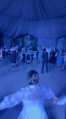 Circle dancing inside a decorated venue in Moldova
