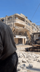 Food distribution and demolition activity across a damaged Gaza neighborhood
