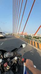 Motorcycle crosses suspension bridge in Đà Nẵng