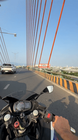 Motorcycle crosses suspension bridge in Đà Nẵng