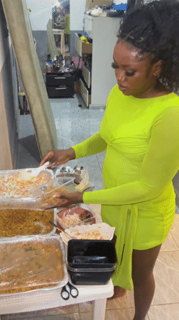 Woman prepares food in tiled kitchen, Kuchingoro Nigeria