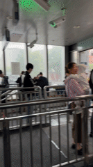 Early morning commuters shelter from rain at Beijing subway station