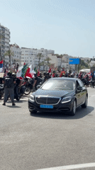 International motorcycle rally rolls through Tangier with flags flying