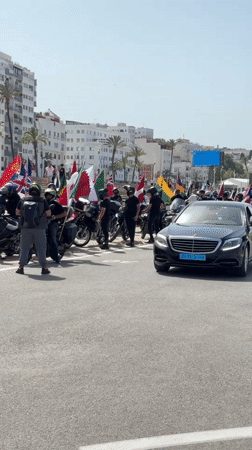 International motorcycle rally rolls through Tangier with flags flying