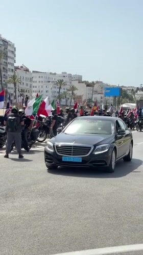 International motorcycle rally rolls through Tangier with flags flying