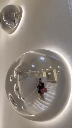 Woman in black dress walks up stairs near Dubai clinic