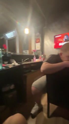 Man checks phone at counter in Kocherinovo