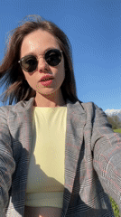 Woman takes selfies on scenic road near Kranj, Slovenia