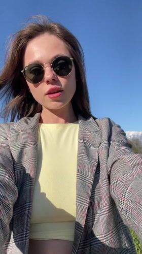 Woman takes selfies on scenic road near Kranj, Slovenia