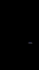 Nighttime cruise ship spotted with colored lights on water