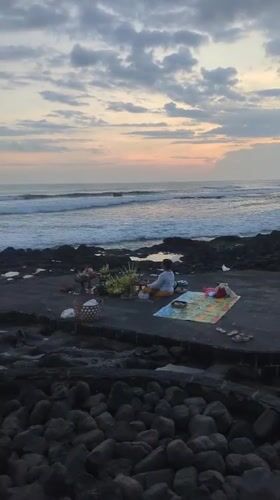 Traditional oceanside ceremony and beach sunset activities in Indonesia