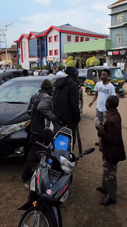 Street activity outside a phone shop in Jos, Nigeria