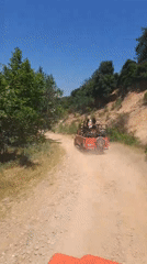 Jeeps traverse dirt road through wooded area near Kuşadası