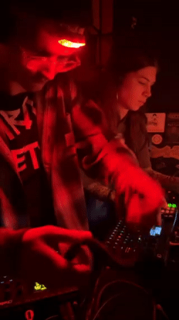 Electronic music event with red lighting documented in Zagreb