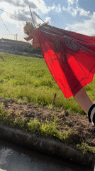 Person flies dragon kite on brick path in Kediri