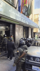Riot police gather outside building in La Paz