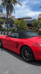 Red Porsche, delivery rider share busy Denpasar street scene