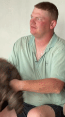 Man poses with tortoiseshell cat in Chaikovsky indoor portrait