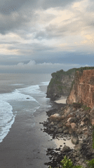 Clifftop gathering captured along Kuta Selatan coastline during overcast morning