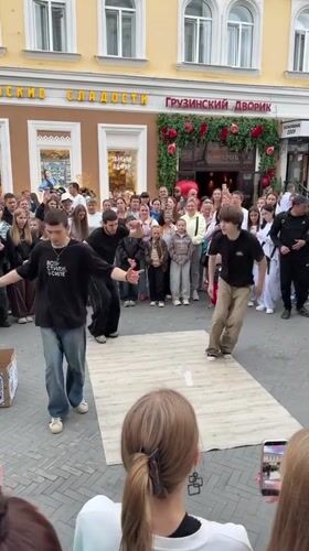 Breakdancers perform on a wooden stage for a Kazan crowd.